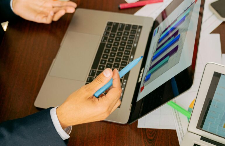 Free A Person in Black Suit Holding a Pen Stock Photo